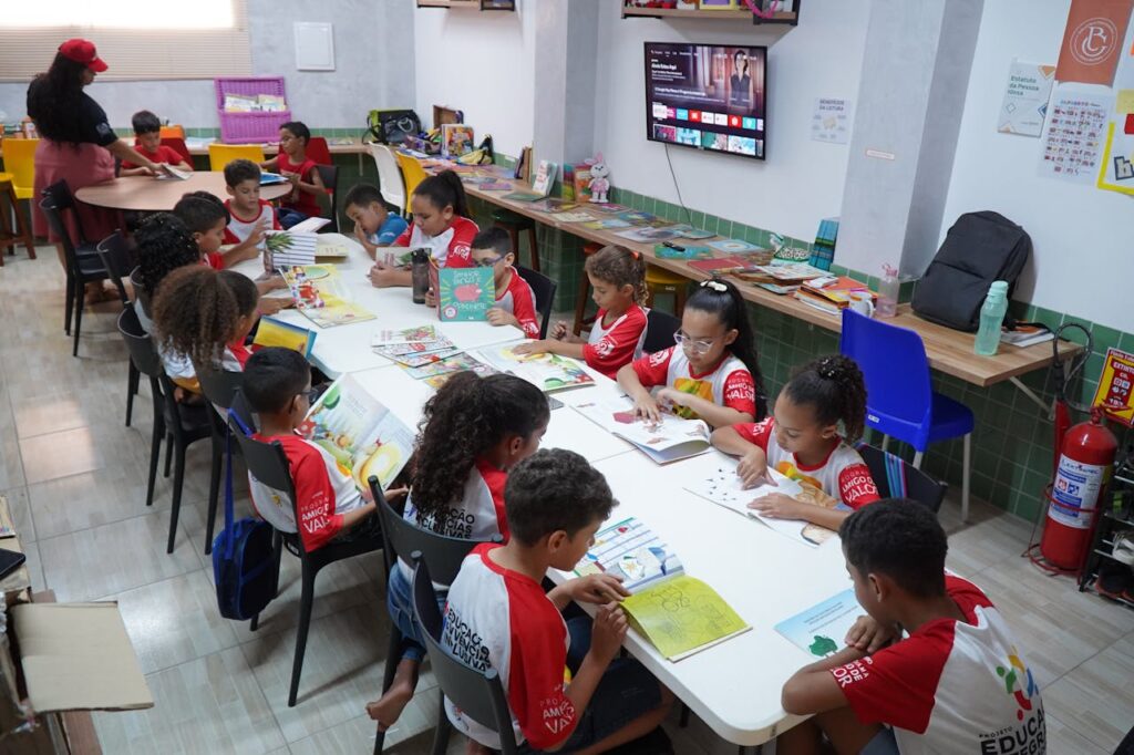 Children engaged in reading at a community library in Glória do Goitá, Brazil.